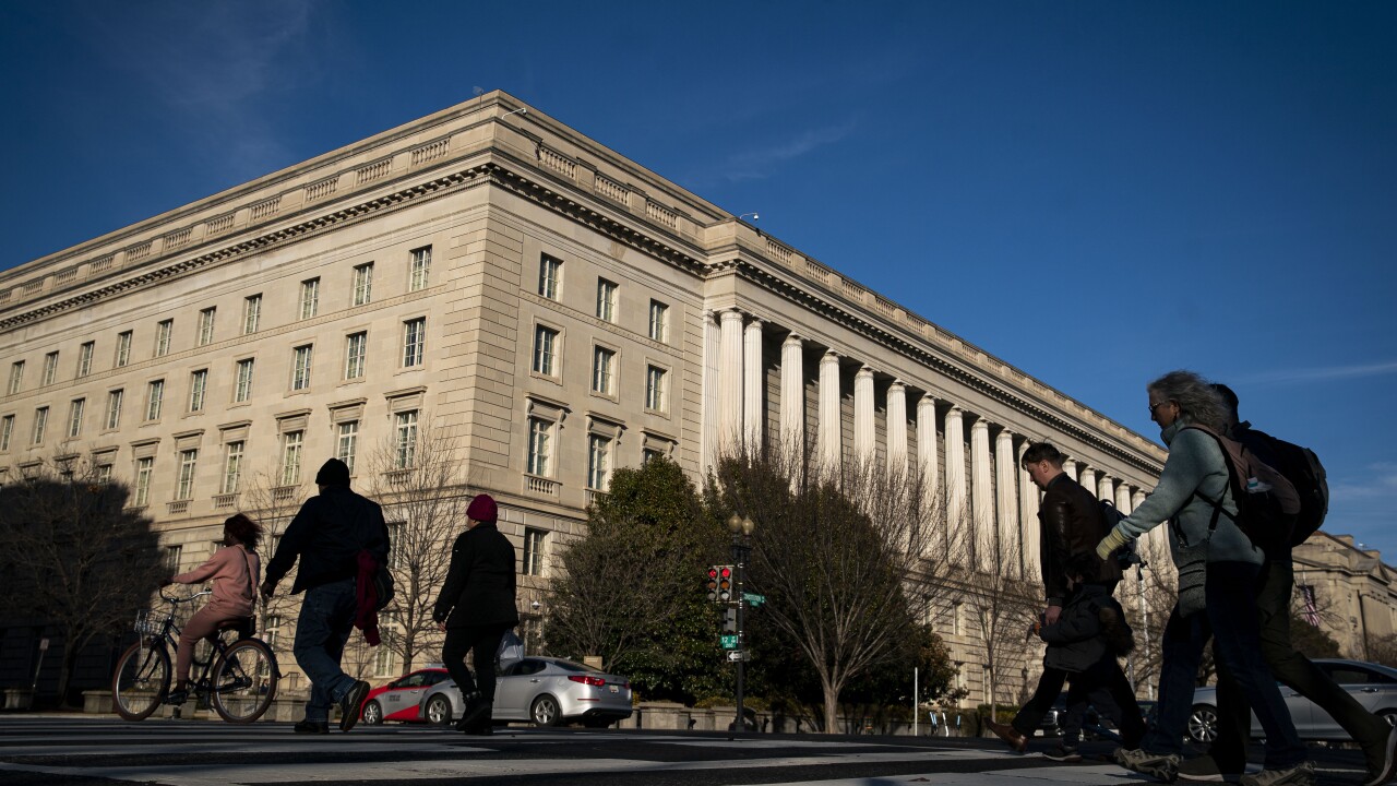 Pedestrians walks past the IRS headquarters in Washington.