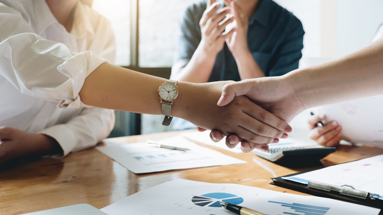 Close up of Business people shaking hands, finishing up meeting,