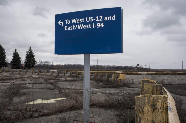 A sign direction to highways stands at the former site of the General Motors Co. powertrain plant inside the Willow Run airport in Ypsilanti, Michigan, U.S., on Wednesday, Feb. 3, 2016.