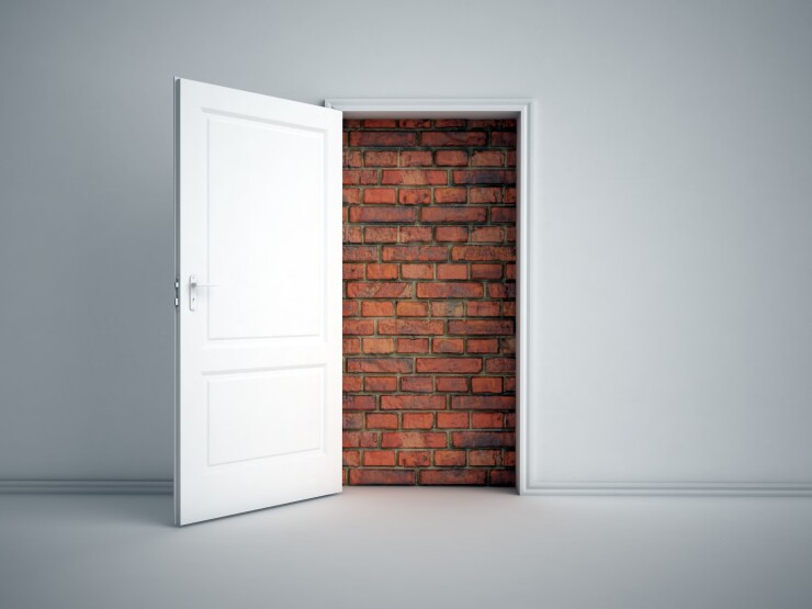 Door opening to a brick wall