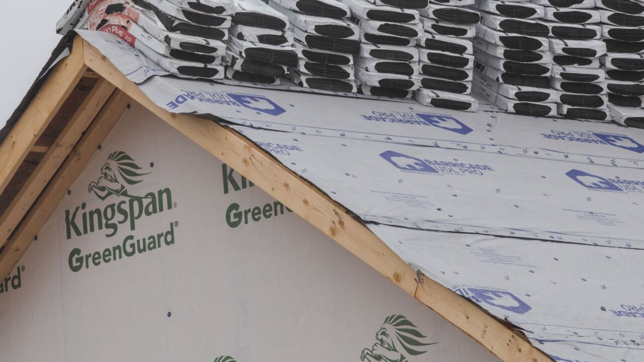 Roofing tile packs on the roof of a home under construction