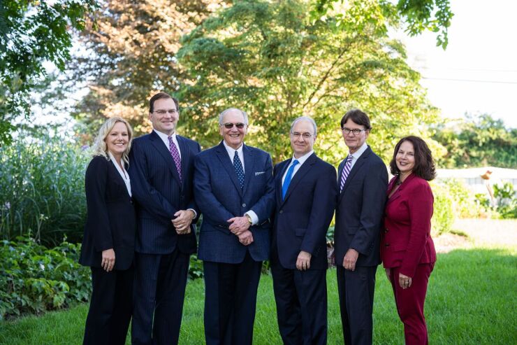 Advisors Asa Graves (second from left), his father A. Wesley Graves (middle left) and Douglas Light (second from right) left Wells Fargo to launch their own RIA. Joining them as a founding partner is attorney Jeffrey Lenhart (middle right). Also moving with the team are senior client associates Kara Morgan (far left) and Angela Moats (far right).