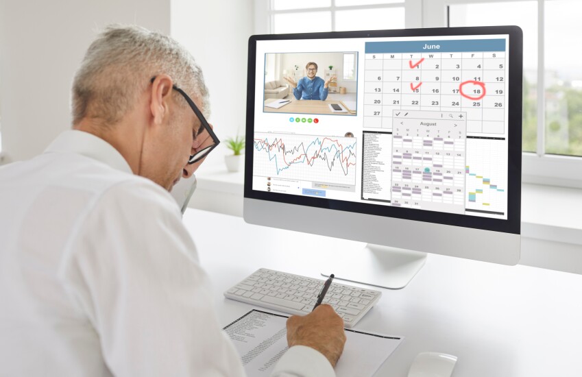 Man facing computer screen with calendar, graf and meeting