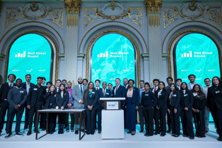 Wall Street Bound founder Troy Prince (front row, left side of podium), the organization's staff and its latest group of current and future financial professionals rang the closing bell in a visit to the New York Stock Exchange last month.