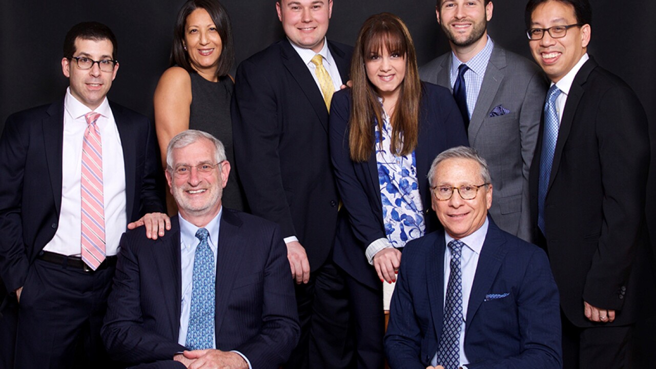 After more than a decade with Wells Fargo, a nine-member team moved its practice to Raymond James for its corporate culture and platform. Left to right: (Seated) Stephen Adler, Mark Levy, (Standing) Michael Lubin, Allison Guzman, Christopher Swanson, Loriann Montanez, Stephen Orzo, Roger Jee