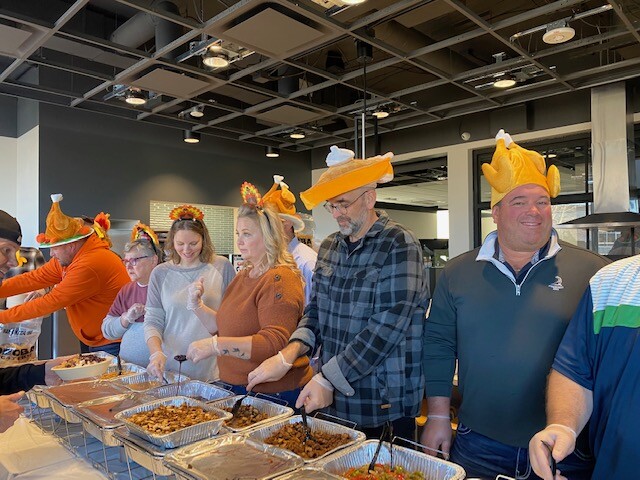 Expansion Capital Group employees serve up a Thanksgiving meal.