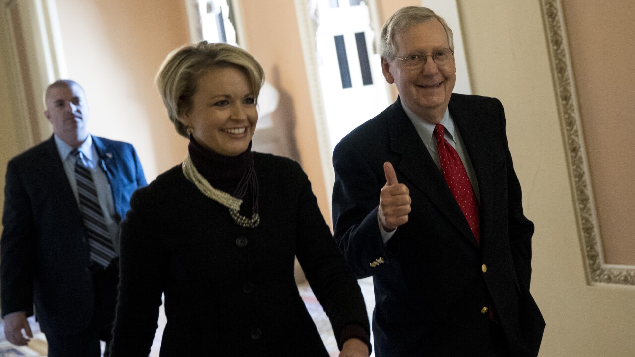 Senate Majority Leader Mitch McConnell, a Republican from Kentucky, gives a thumbs up while walking to the Senate floor at the U.S. Capitol in Washington, D.C., U.S., on Friday, Dec. 1, 2017.