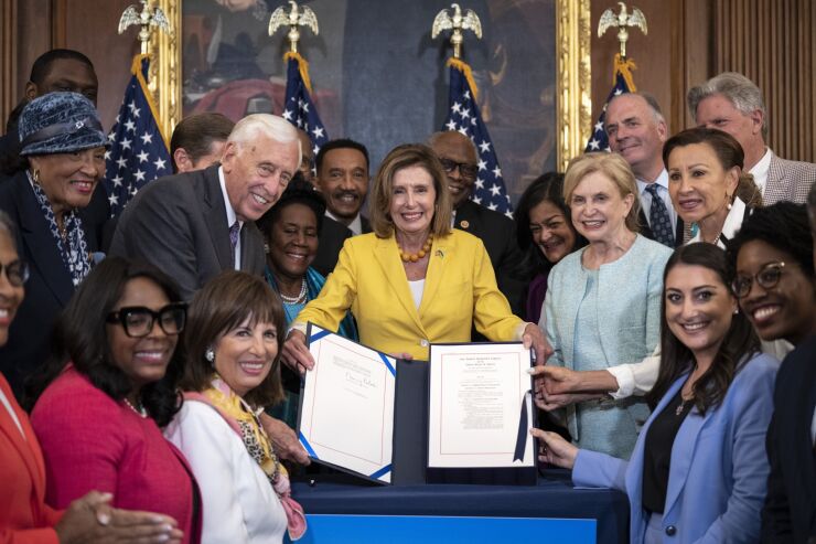 WASHINGTON, DC - AUGUST 12: House Democrats pose for photos after Speaker of the House Nancy Pelosi (D-CA) signed the Inflation Reduction Act during a bill enrollment ceremony after the House passed the legislation at the U.S. Capitol August 12, 2022 in Washington, DC. The $737 billion legislation will focus on slowing climate change, lower health care costs and creating clean energy jobs by enacting a 15% corporate minimum tax, a 1% fee on stock buybacks and enhancing IRS enforcement. (Photo by Drew Angerer/Getty Images)