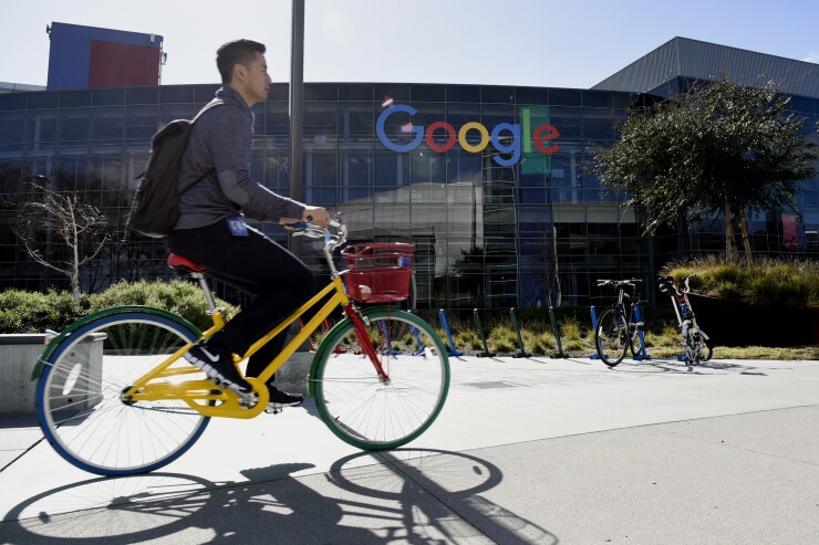 A cyclist rides past Google Inc. offices inside the Googleplex headquarters in Mountain View, California, U.S., on Thursday, Feb. 18, 2016.