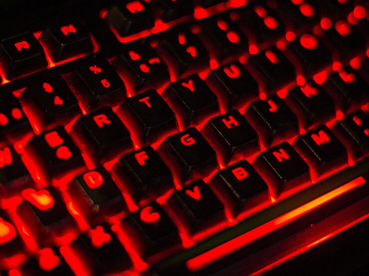A keyboard is illuminated as gamers play video games at the Dreamhack digital festival in Moscow on Dec. 5, 2015.