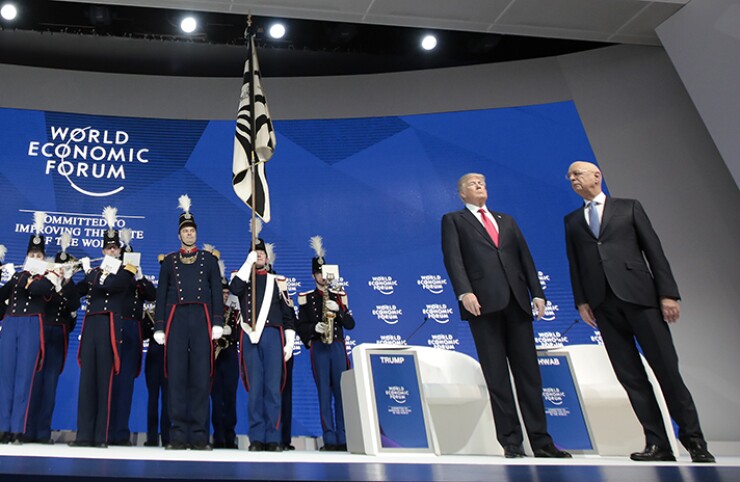 President Donald Trump, second from right, and Klaus Schwab, chairman of the World Economic Forum stand on stage as a band plays during a special address on the closing day of the World Economic Forum in Davos.