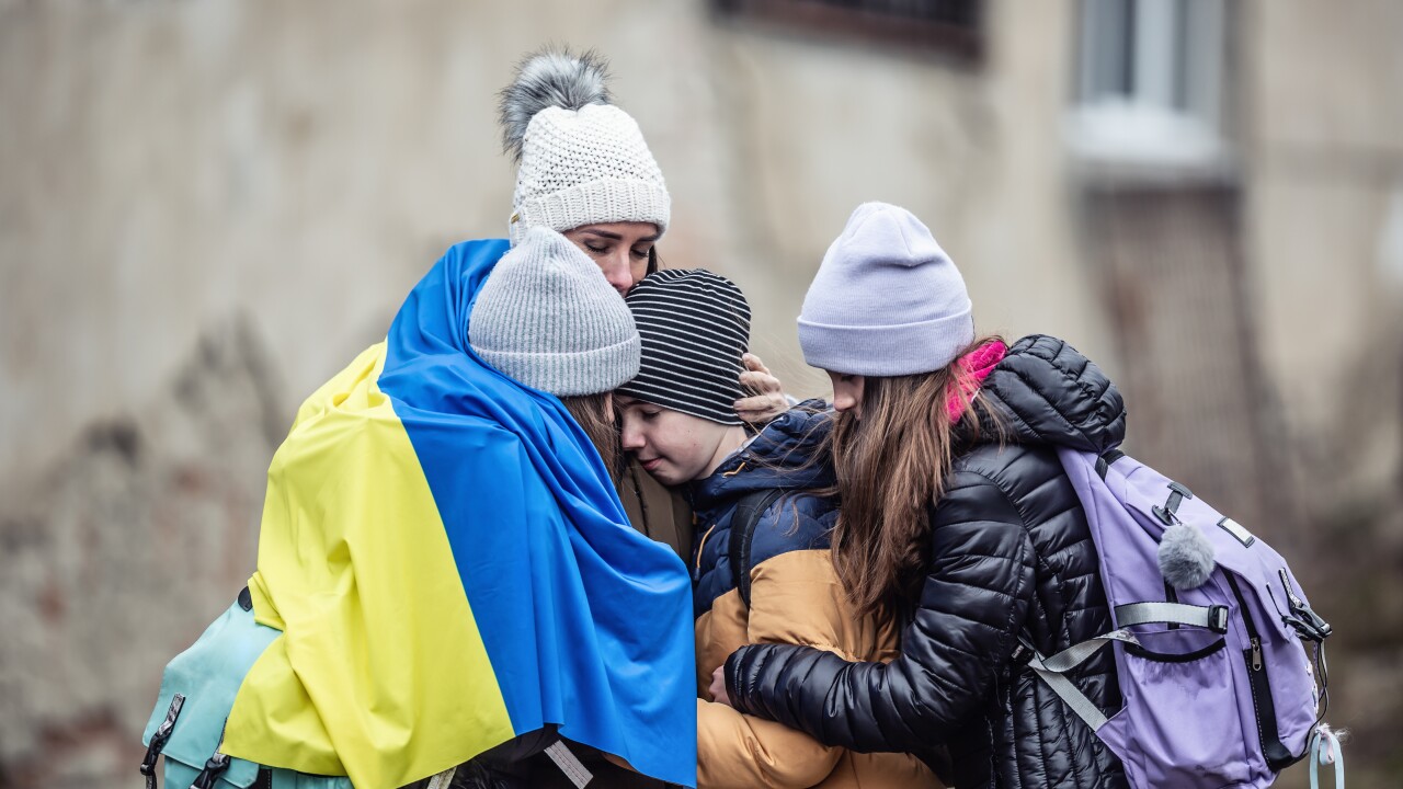 A Ukrainian mom and her three children huddled together.