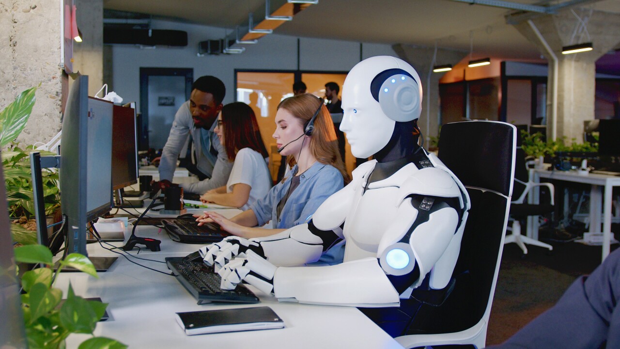 Robot working at computer among people. Maschine typing on keyboard in office. IT team of future. Futuristic worker. Humanoid work at call center. Support job. Selling concept. Technologies.