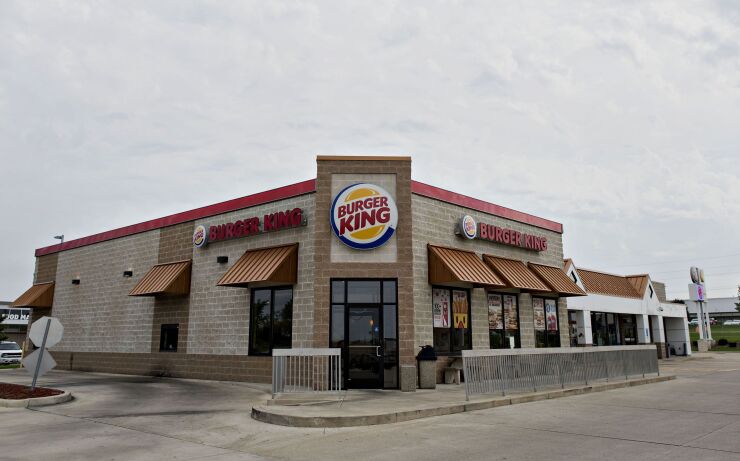 A Burger King Worldwide Inc. restaurant stands in Peoria, Illinois, U.S., on Tuesday, Aug. 26, 2014. Warren Buffetts Berkshire Hathaway Inc. is providing financing for Burger King Worldwide Inc.s planned takeover of Tim Hortons Inc., the latest deal being backed by a commitment from the billionaire. Photographer: Daniel Acker/Bloomberg