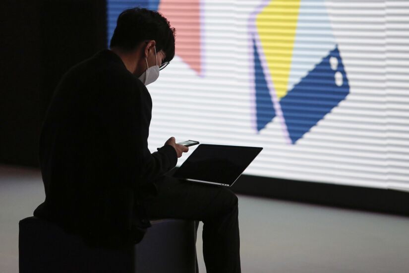 An attendee works at a laptop computer on the opening day of the MWC Barcelona at the Fira de Barcelona venue in Barcelona, Spain, on Monday, Feb. 28, 2022. Over 1,800 exhibitors and attendees from 183 countries will attend the annual event, which runs from Feb. 28 to March 3. Photographer: Angel Garcia/Bloomberg