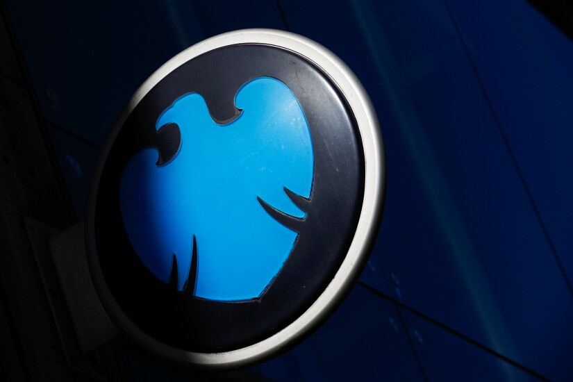 A logo for a Barclays bank branch sits on a sign in London.