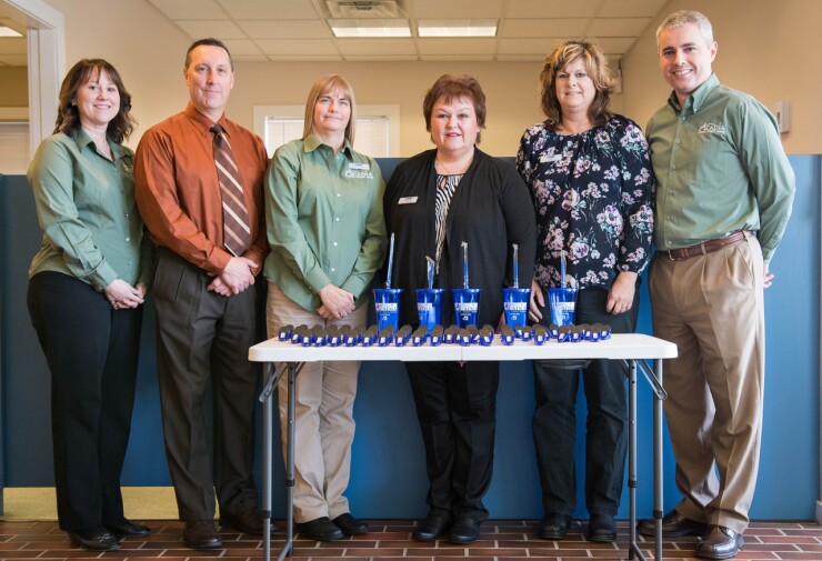 Acadia Federal Credit Union staff members celebrating the completion of the CU's merger with Eastern Maine Medical Center FCU.
