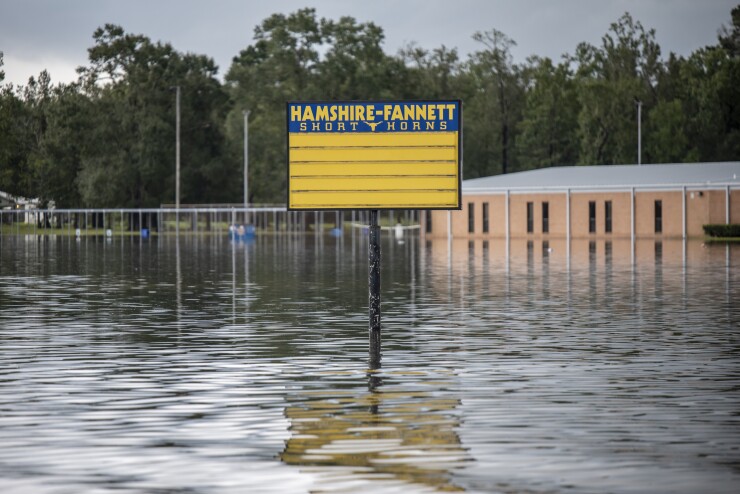 Flood water surrounds a sign for Hamsire-Fannett High School following Tropical Storm Imelda in Fannett, Texas, U.S., on Friday, Sept. 20, 2019. The remnants of Tropical Storm Imelda lashed Houston and coastal Texas, inundating homes, paralyzing travelers, disrupting oil supplies, and threatening hospitals and refineries. Photographer: Sergio Flores/Bloomberg