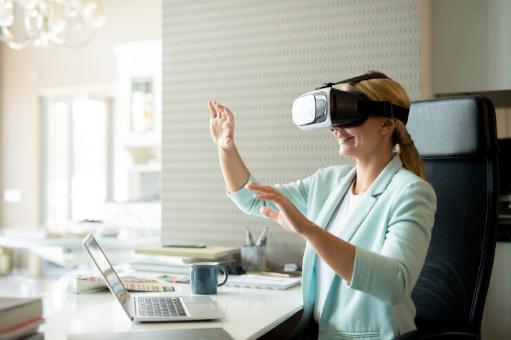 Young female employee in vr goggle attenting virtual training