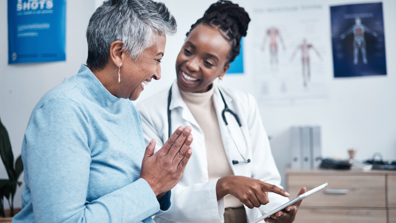Woman speaking with female doctor