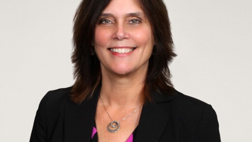 A woman smiling for a photo.