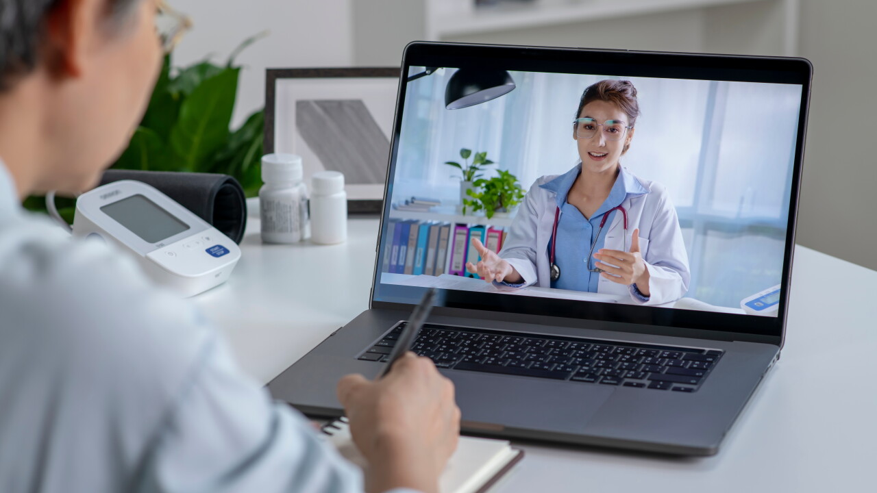 Woman talking with doctor, virtual appointment on laptop