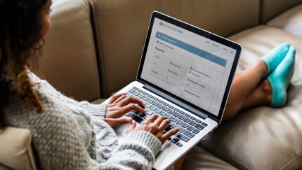 A woman using her laptop to bank online.