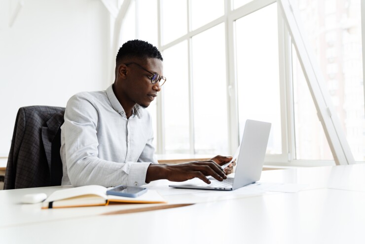 Male employee working on laptop