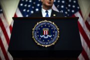 The seal of the Federal Bureau of Investigation hangs on a podium during a news conference at the FBI headquarters in Washington.