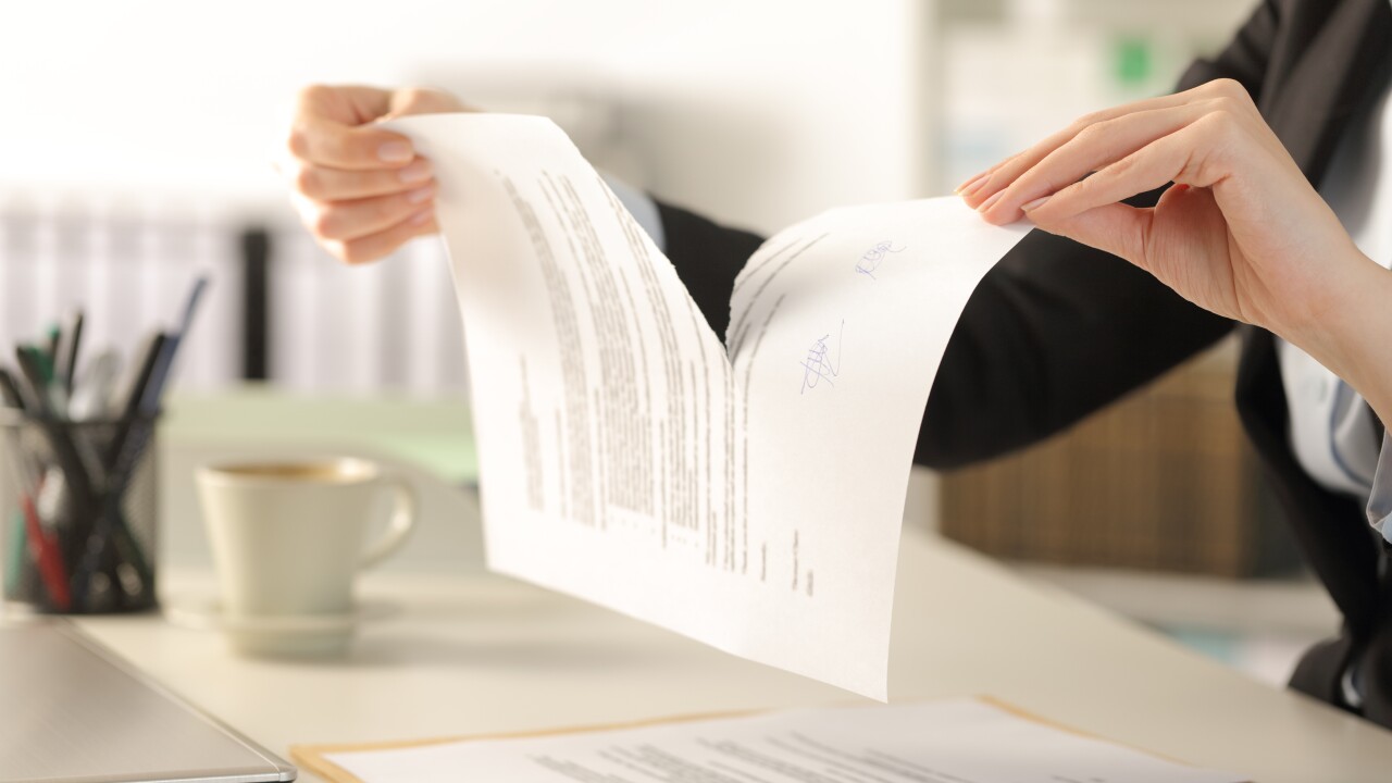 Business woman hands breaking document at the office