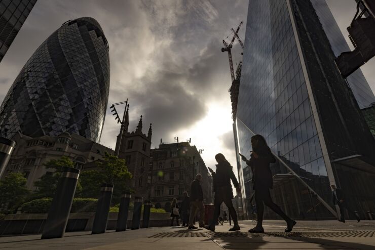 Morning commuters walk past skyscrapers including 30 St. Mary Axe, also known as The Gherkin, left, in the City of London, UK, on Monday, May 16, 2022. The Office for National Statistics (ONS) will release the latest UK Labor Market Statistics on Tuesday. Photographer: Jason Alden/Bloomberg