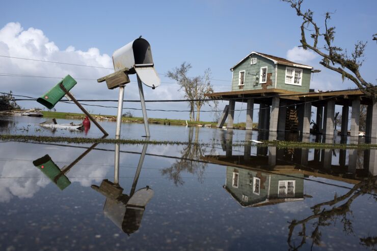 A damaged home in floodwater after Hurricane Ida in Pointe-Aux-Chenes, Louisiana, U.S., on Thursday, Sept. 2, 2021. The electric utility that serves New Orleans has restored power to a small section of the city after Hurricane Ida devastated the region's grid. Photographer: Mark Felix/Bloomberg