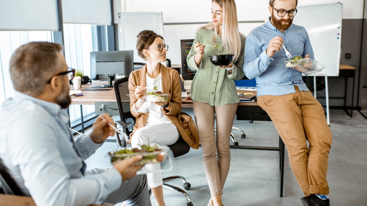 Group of employees eating healthy at work