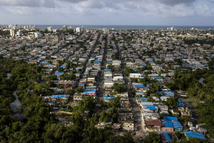 Blue roof temporary tarps are seen in an aerial photograph taken over San Juan, Puerto Rico.