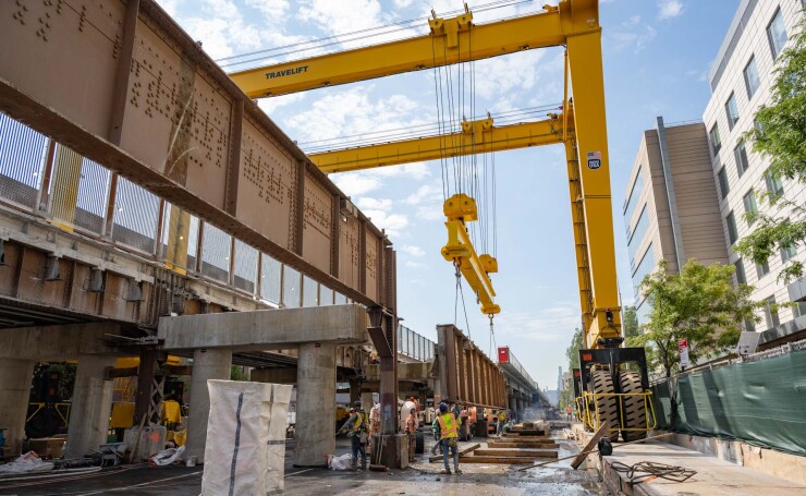 Construction workers operate a crane while working on the Park Avenue Viaduct Replacement