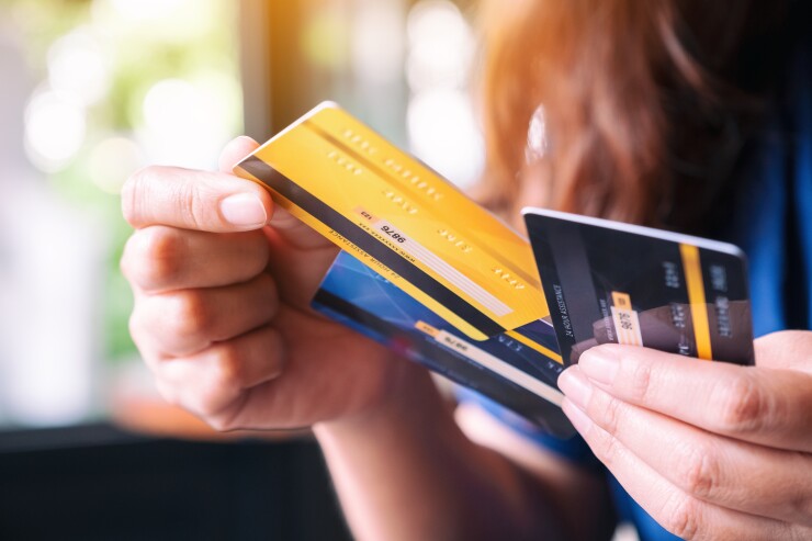 Woman holding a stack of credit cards