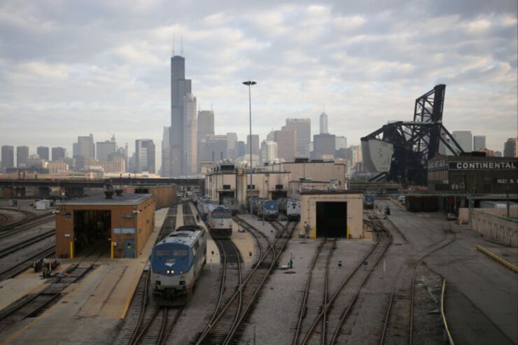 Amtrak locomotives sit parked at the 18th Street locomotive shop as the Willis Tower stands in the skyline of Chicago, Illinois, U.S., on Wednesday, Oct. 7, 2015. The head of Amtrak warned Congress that some passenger rail service outside the Northeast corridor will be suspended if lawmakers don't extend a Dec. 31 deadline for railroads to install safety technology. Photographer: Luke Sharrett/Bloomberg