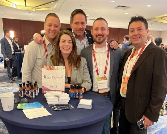 IOU Financial employees at a deBanked conference table with branded hot sauce samples.