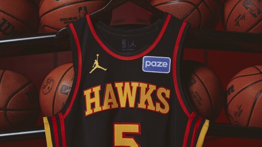 An Atlanta Hawks jersey with a Paze patch in front of basketballs.