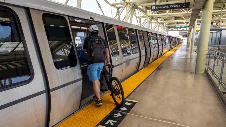 Rider with bicycle boards San Francisco Bay Area Rapid Transit District train.