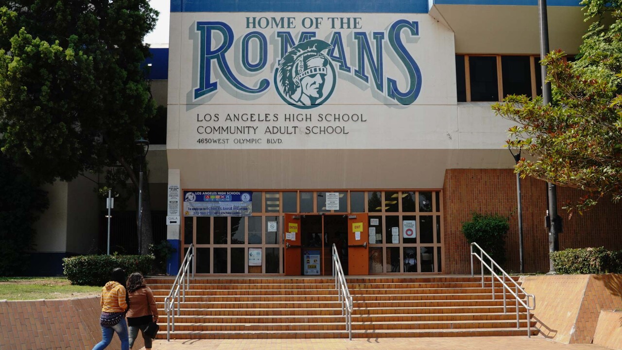 A parent and child enter Los Angeles High School