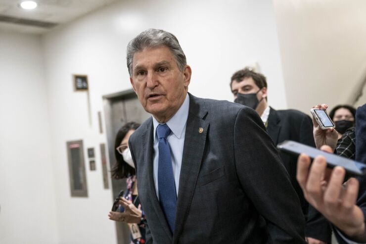 Senator Joe Manchin, a Democrat from West Virginia, speaks to members of the media at the U.S. Capitol in Washington, D.C., U.S., on Wednesday, Dec. 15, 2021. The House and Senate voted to raise the nation's debt ceiling by $2.5 trillion, an amount intended to extend the government's borrowing authority past next year's congressional elections and into early 2023.