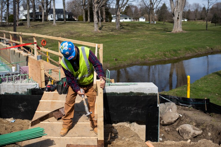 A contractor installs a safety walkway at a bridge construction site in Michigan.