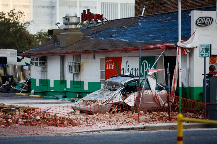 A damaged car next to the debris of a collapsed two-story building after Hurricane Ida in downtown New Orleans, Louisiana, U.S., on Thursday, Sept. 2, 2021. The electric utility that serves New Orleans has restored power to a small section of the city after Hurricane Ida devastated the region's grid. Photographer: Eva Marie Uzcategui/Bloomberg