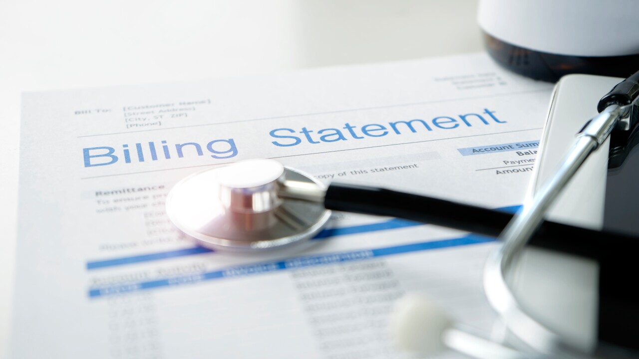 A billing statement for health care expenses rests on a table.