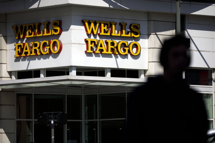 Signage is displayed outside a Wells Fargo bank branch in Los Angeles.