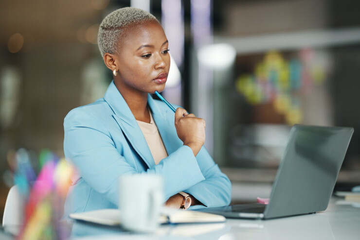 Laptop, idea and a serious businesswoman in her office on a review, proposal or project. Work, focus and thinking with a female employee reading an email or doing research while working