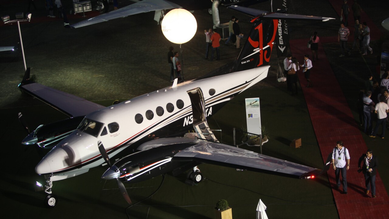 Visitors walk around a Hawker Beechcraft King Air 250 on the last day of 9th annual Latin American Business Aviation Conference and Exhibition in Sao Paulo, Brazil on Friday, Aug. 17, 2012. Municipal bond fraudster Christopher Brodgon has a similar airplane.