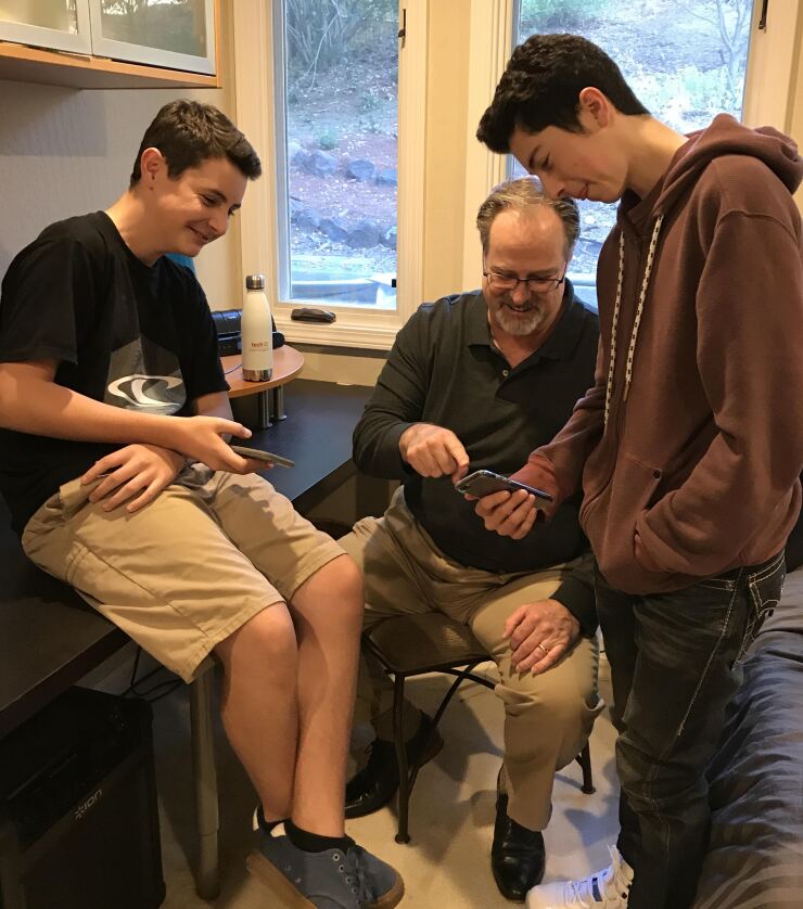 Tech CU CEO Todd Harris, pictured with his two sons. The credit union’s Family Banking product was Harris’ idea based on his wanting a better way to interact financially with his kids.