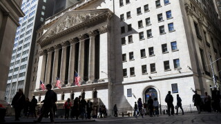 People milling about in a courtyard outside The New York Stock Exchange in New York City.